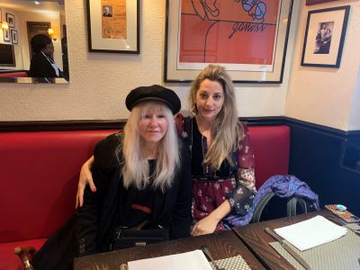 Two women sitting in a restaurant booth