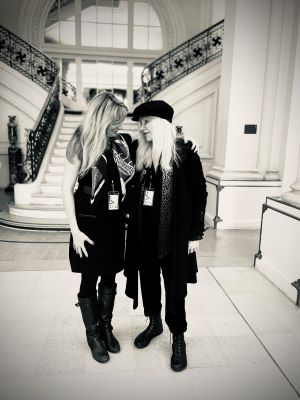 Black and white photo of two woman in an elegant foyer